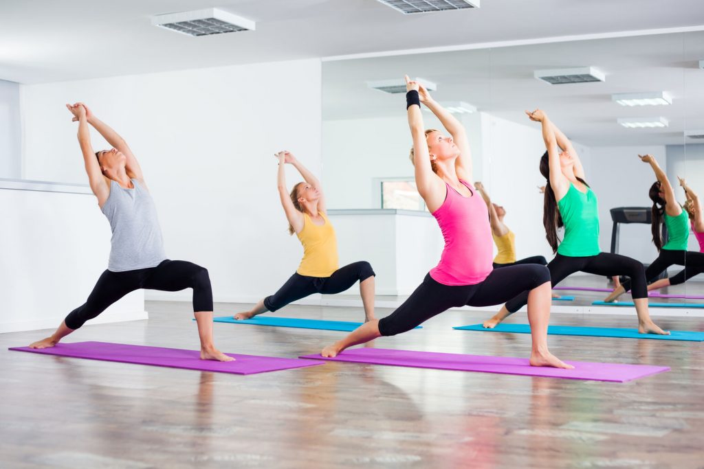 44845280 – four girls practicing yoga, yoga – virabhadrasanawarrior pose